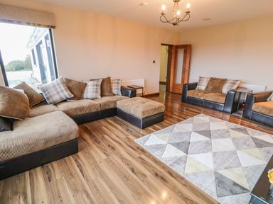 A living room with sofas cushions ottoman and geometric rug at Upper Killult in Killult near Gortahork County Donegal