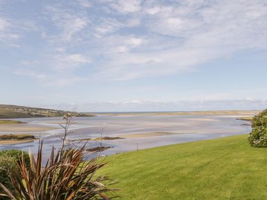 A coastal landscape with grassy hills overlooking a sandy tidal estuary at Upper Killult in Killult near Gortahork County Donegal