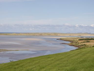 A coastal landscape with grassy foreground and water body at Upper Killult in Killult near Gortahork County Donegal