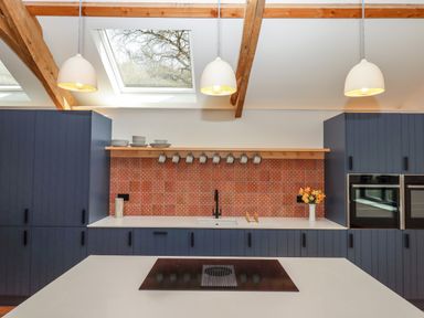 A kitchen with blue cabinets white countertops a sink and stove with pendant lighting and skylights at 3 Caddaford Barns Buckfastleigh