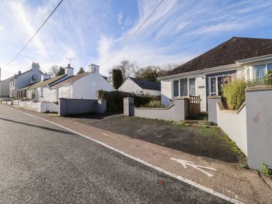 A street with white houses and a small fenced front yard at The Croft in Newport Pembrokeshire