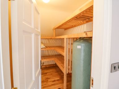 A small storage room with wooden shelves and a large cylindrical tank at Hazelwood in Leap County Cork