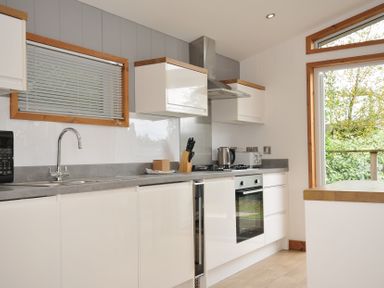 A kitchen with a stove and sink at 3 Southern Place in Dobwalls