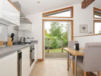 A kitchen with a dining table and chairs at 3 Southern Place in Dobwalls