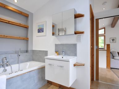 A bathroom with a bathtub and sink at 3 Southern Place Dobwalls