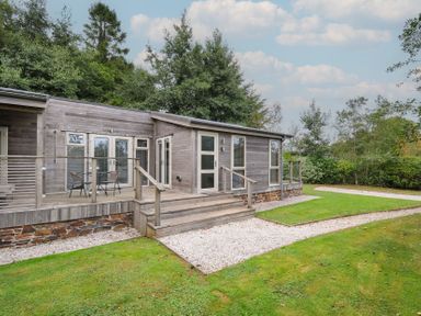 A cabin exterior with steps and a deck at 3 Southern Place in Dobwalls