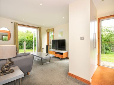A living room with a television and sofa at 5 Faraway Fields in Dobwalls