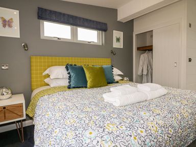 A bedroom with a patterned bedspread on a bed at 19 Meadow Retreat in Dobwalls