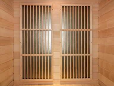 Two wooden framed panels with vertical bars inside a room with wooden walls at 19 Meadow Retreat in Dobwalls