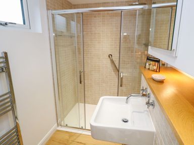 A bathroom with a shower enclosure sink and towel rack at 12 Faraway Fields in Dobwalls