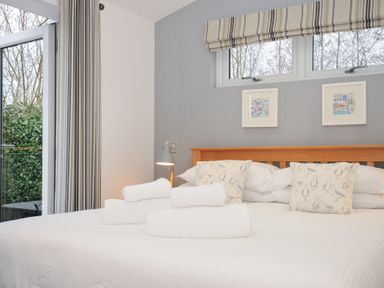 A bedroom with a bed and towels at 15 Faraway Fields in Dobwalls