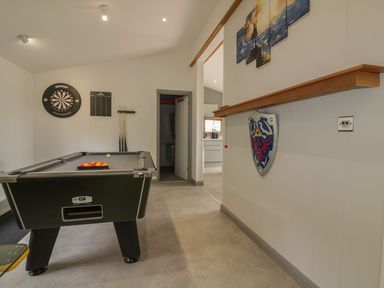 A game room with a pool table darts and cues on the wall at 18 Meadow Retreat in Dobwalls