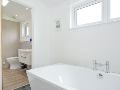 A bathroom featuring a bathtub and toilet at 1 Horizon View, Dobwalls