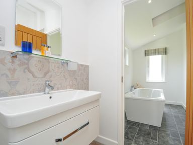 A bathroom with a sink and bathtub at 1 Horizon View in Dobwalls