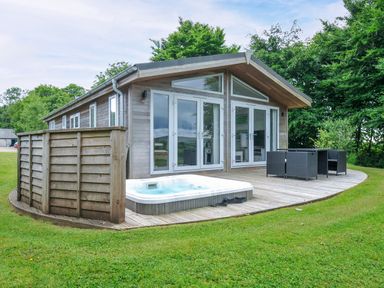 An outdoor area with a hot tub and seating at 1 Horizon View in Dobwalls