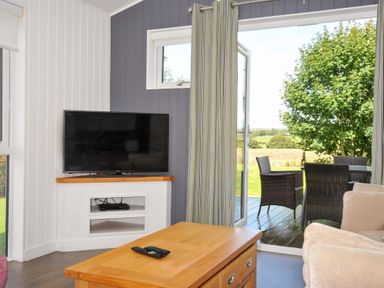 A living room with a television and a coffee table at 3 Horizon View in Dobwalls
