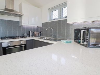 A kitchen with a gas stove microwave kettle toaster and sink at 11 Meadow Retreat in Dobwalls