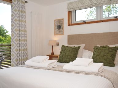 A bedroom with a bed and pillows at 12 Meadow Retreat in Dobwalls