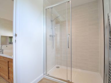 A bathroom featuring a shower and bathtub at 12 Meadow Retreat in Dobwalls