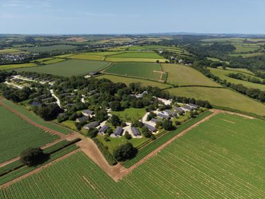 An aerial view of a residential area surrounded by fields at 9 Meadow Retreat in Dobwalls