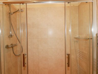 A shower enclosure with glass doors and a wall-mounted showerhead at 14 Horizon View in Dobwalls