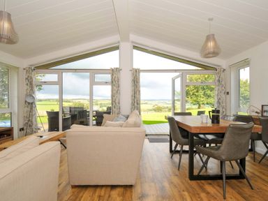 A living room with a dining area and sliding doors at 8 Horizon View in Dobwalls