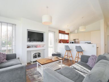 A living room with a television and coffee table at 9 Horizon View in Dobwalls