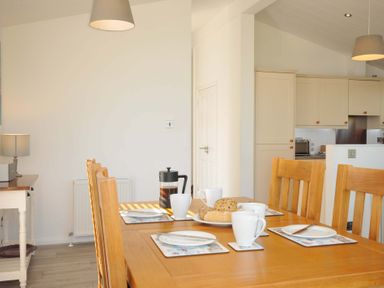 A dining room with a table set for breakfast at 10 Horizon View in Dobwalls