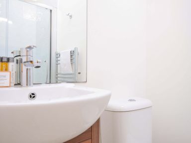 A bathroom with a sink, toilet, and towel rack at 10 Horizon View in Dobwalls