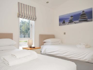 A bedroom with two beds and a window at 10 Horizon View Dobwalls