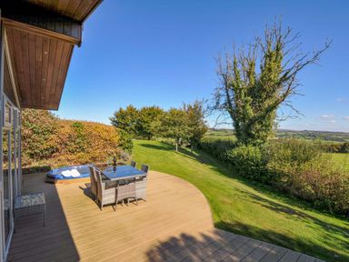 A deck with outdoor furniture and a hot tub at 10 Horizon View in Dobwalls