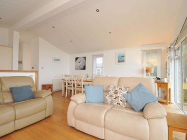 A living room with a sofa and dining table at 11 Horizon View Dobwalls