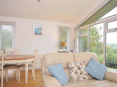 A living room with a sofa and dining table at 11 Horizon View in Dobwalls
