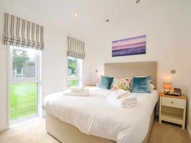 A bedroom with a bed and windows at 11 Horizon View in Dobwalls