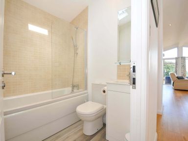 A bathroom with a bath, toilet, and sink at 11 Horizon View in Dobwalls