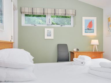 A bedroom with a bed, chair, and drawer at 15 Horizon View in Dobwalls