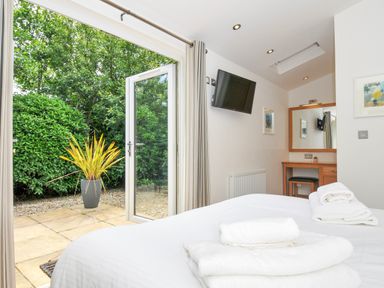 A bedroom with a bed and a view of the garden at 15 Horizon View in Dobwalls