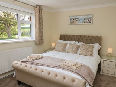 A bedroom with a double bed and bedside tables at Erwlon in Rhydyfelin near Aberystwyth