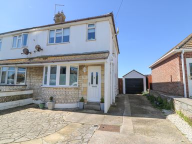 A semi detached house with a driveway leading to a detached garage at Lagoon View in Wyke