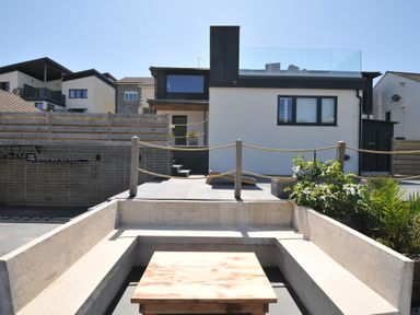 An outdoor area with a house and seating at Breakers View in Polzeath