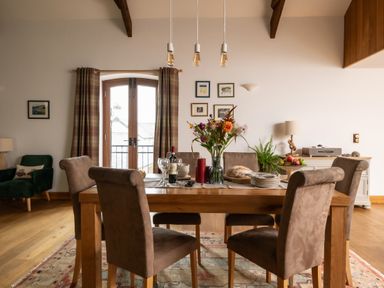 A dining room with a table and chairs at Hoppers Barn Pancrasweek near Holsworthy