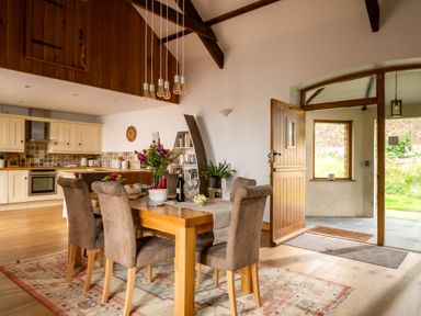 A dining room with a table and chairs at Hoppers Barn Pancrasweek near Holsworthy
