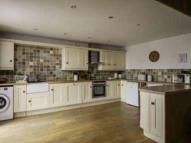 A kitchen with cabinets and appliances at Hoppers Barn in Pancrasweek near Holsworthy