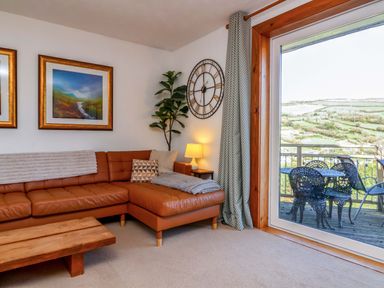 A living room with a sofa and coffee table at Hillsview in Combe Martin