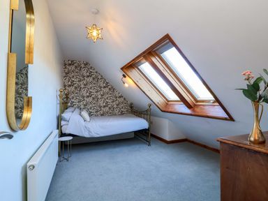 A bedroom with a bed and window at Hillsview in Combe Martin