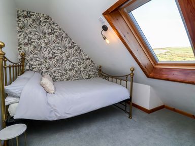 A bedroom with a bed and window at Hillsview in Combe Martin