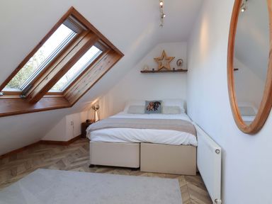 A bedroom with a bed and skylight at Hillsview in Combe Martin