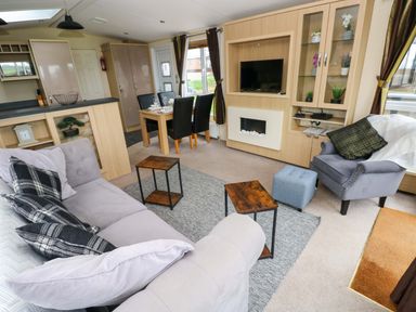 A living room with seating and dining area at Reef Retreat Little Haven