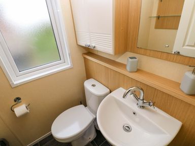 A bathroom with a sink and toilet at Reef Retreat in Little Haven