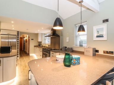 A kitchen with countertops appliances and pendant lights at Blencathra in Keswick